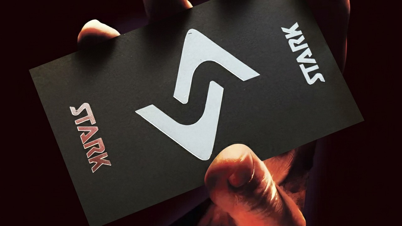 STARK business card in hand